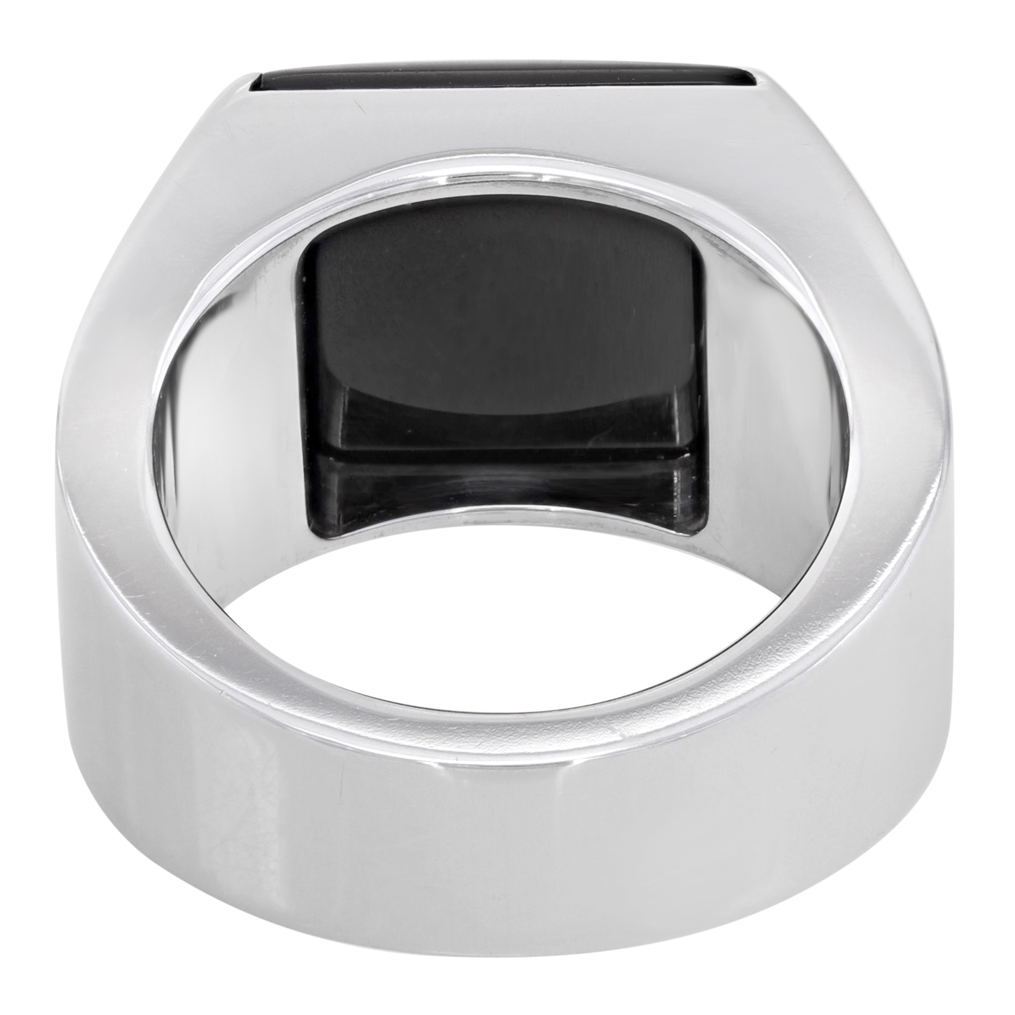 An image of a unisex adult Cartier ring with a prominent gemstone, captured from a top-down perspective. The ring features a sleek, white gold band with a rectangular black Onyx gemstone set flush into the band's top surface. The photo is taken from a close distance, showcasing the ring's reflective metallic finish and the gemstone's facets with high clarity. Great preowned condition.