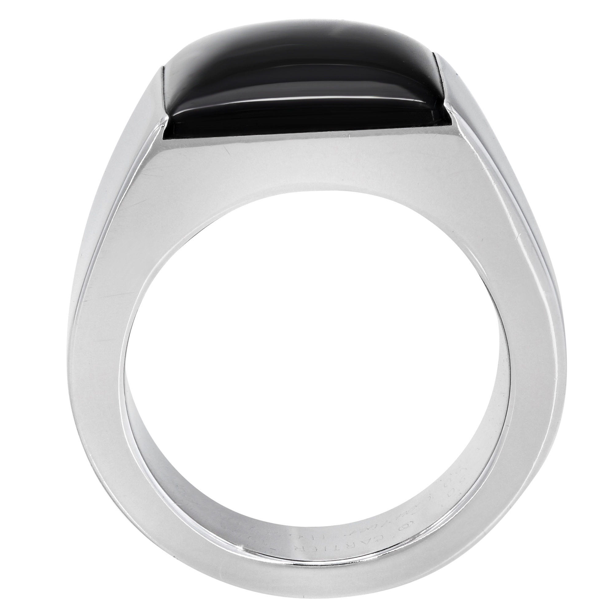 An image of a Cartier unisex adult ring with gemstone, viewed from a top-down angle. The ring features a large, black Onyx gemstone set in a polished white gold band. The gemstone is positioned at the top center of the ring, which is captured in close-up, filling the frame for detailed viewing. Great preowned condition.