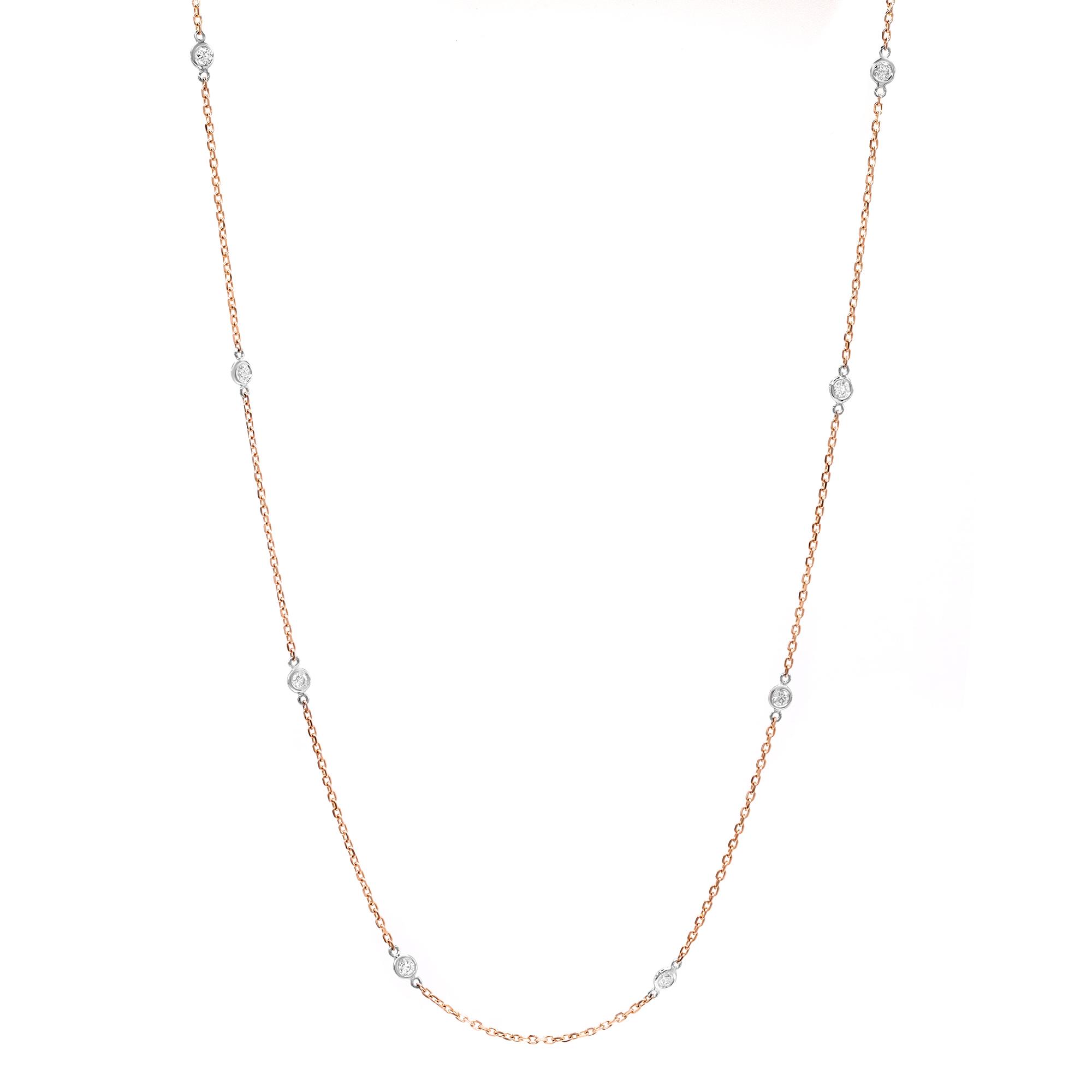An image of a Rachel Koen brand diamond by the yard women's necklace set in 14k rose gold with white gold bezel setting. The necklace is displayed against a white background and is positioned in a slight S-curve, showing the full length of the chain. The perspective is head-on and the necklace is centered in the frame, providing a clear and detailed view at a medium distance.