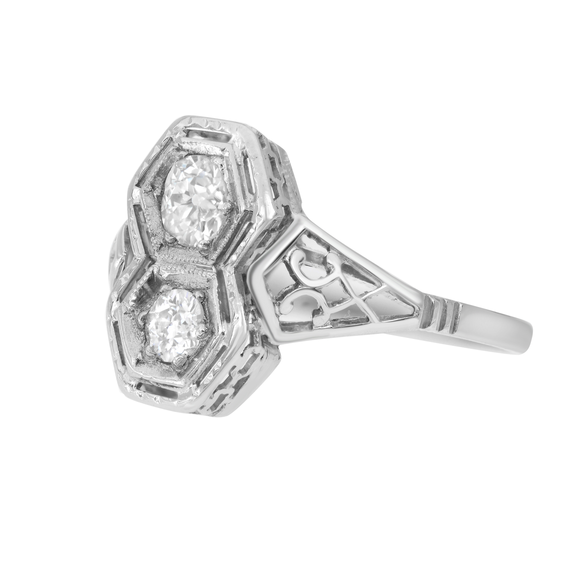 An image of a Rachel Koen women's ring with diamonds, captured from a top-down perspective. The ring features a prominent hexagonal setting with two large, round-cut diamonds at its center, each nestled within individual hexagonal frames. The band of the ring tapers smoothly from the base of the setting down to the bottom. The photograph is taken from a close distance, highlighting the intricate details and the reflective surfaces of both the diamonds and the polished white gold metal.The ring is pre owned in a good condition. 