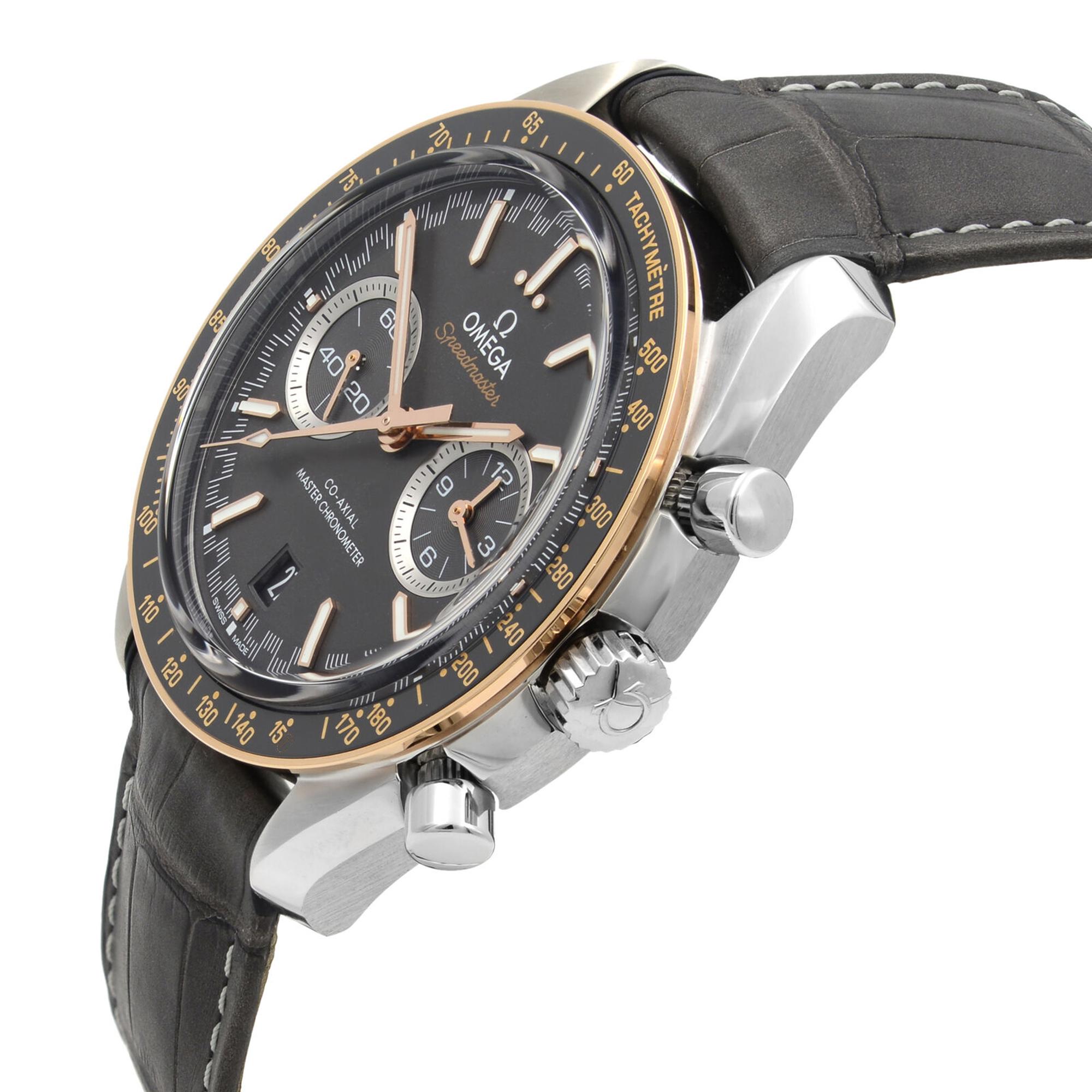 An image of a men's OMEGA wristwatch positioned at a slight angle, showcasing its chronograph features and small seconds subdial. The watch is new with defects and has a grey dial with rose gold-tone accents. It is photographed from a close distance, highlighting the detailed craftsmanship and the tachymetric scale on the bezel. The gray leather strap and polished steel case are also visible.
