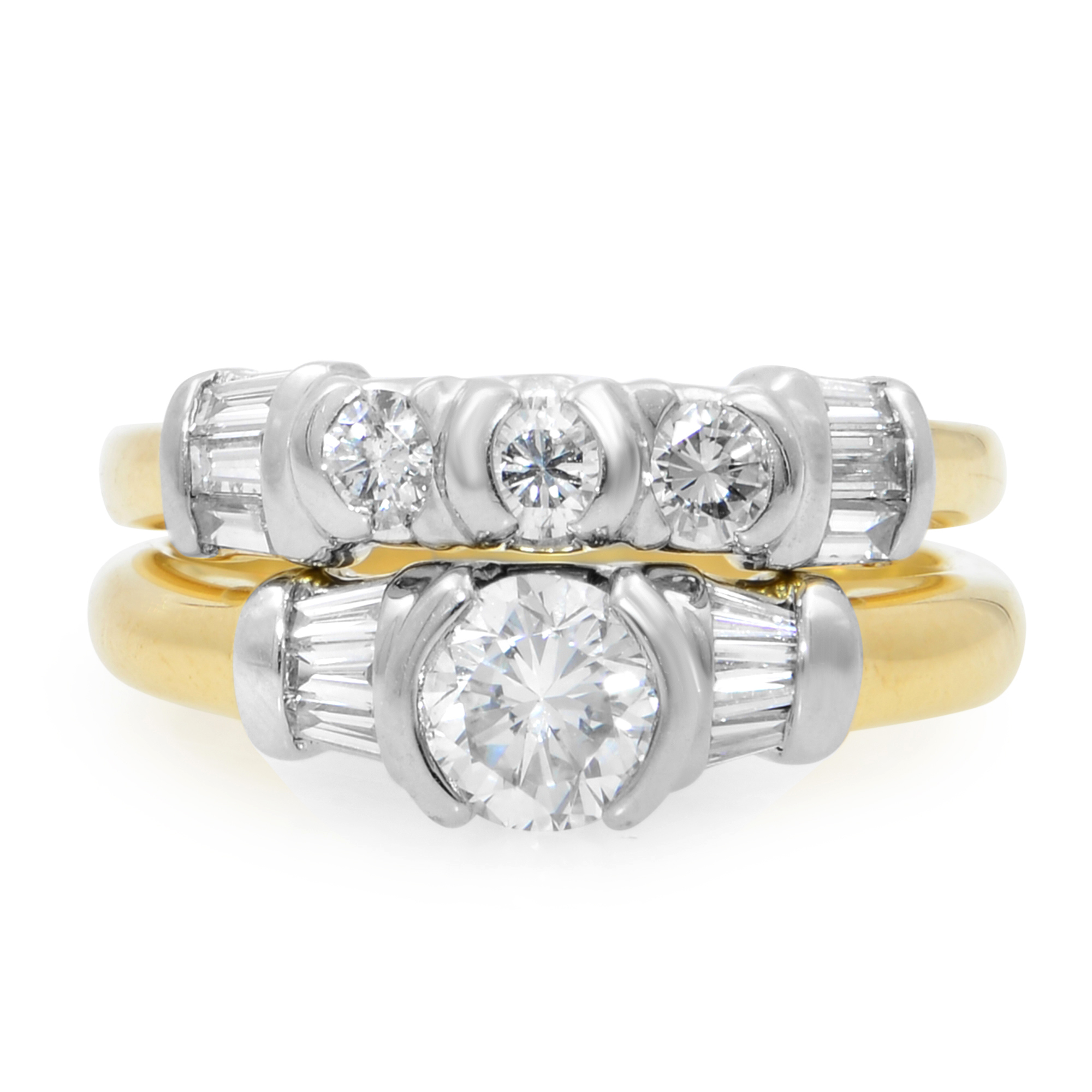 An image of a Rachel Koen women's engagement ring with wedding band in diamonds, displayed frontally at a close distance with a slight angle to show the ring's depth. The ring features a large central round cut diamond with baguette cut diamonds on both sides set in a white gold and yellow gold band, flanked by smaller diamonds on the wedding band. The band transitions to yellow gold as it encircles the finger, emphasizing the two-tone design.