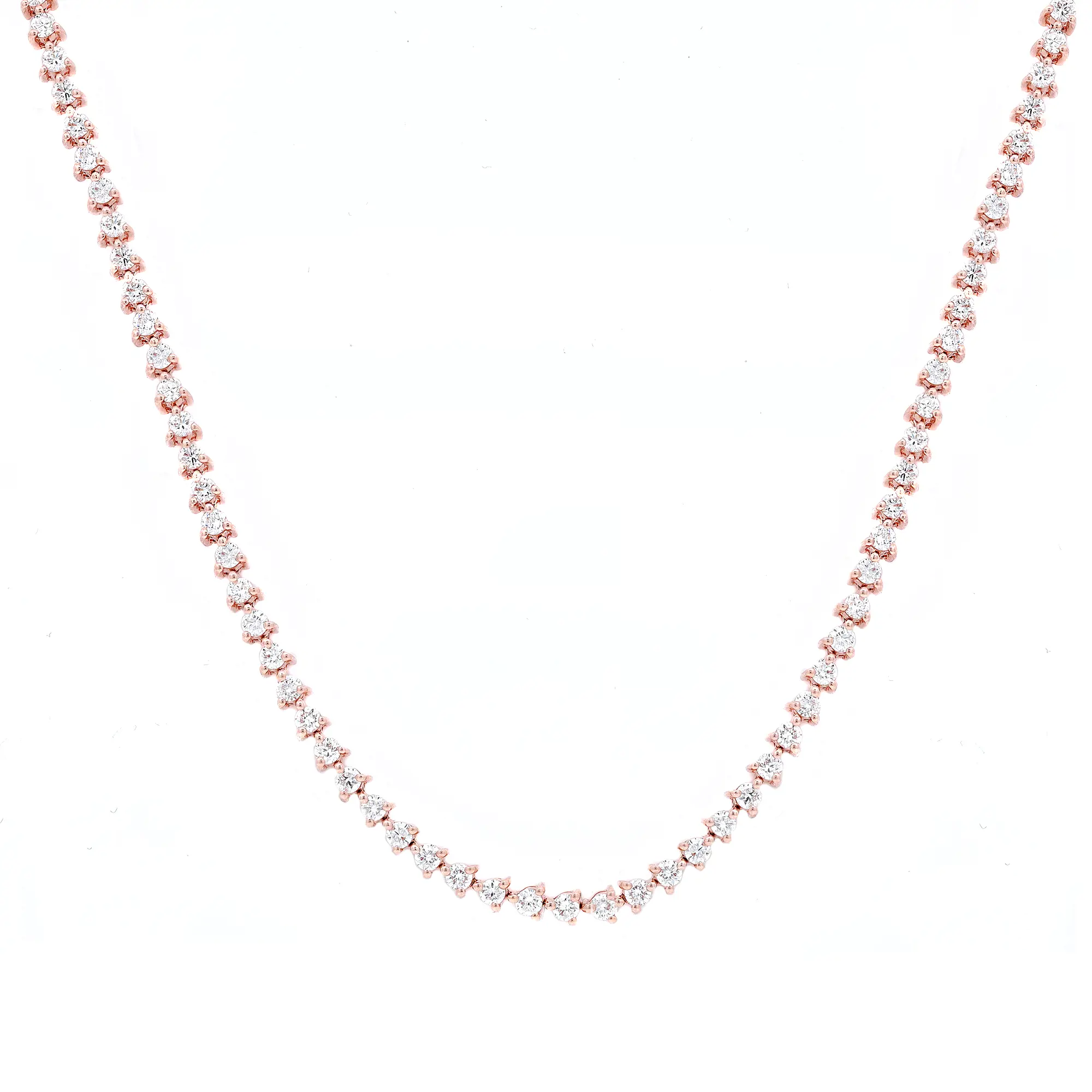 An image of a Rachel Koen women's necklace with diamonds, displayed against a white background. The necklace features a single strand of round-cut diamonds set in a three prong setting, creating a continuous line of sparkle in rose gold. The necklace is presented in a slightly curved, horizontal position at the center of the image, with the perspective giving a natural view as if laid out on a surface. The distance from the camera ensures the entire length of the necklace is visible, providing a clear view of the craftsmanship and the consistency of the diamond settings.