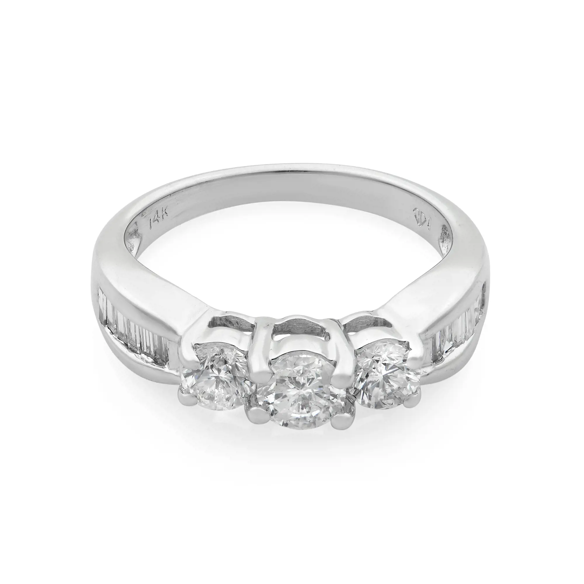 An image of a Rachel Koen women's wedding ring with diamonds, presented in a close-up side view showcasing the band's design and the setting of the stones. The ring features a polished white gold band with a 14K mark visible inside, indicating its purity. In the center, three round-cut diamonds are mounted in a shared prong setting, flanked by channel-set baguette diamonds along the shoulders of the band, enhancing the ring's brilliance and elegance. The image is captured at a slight angle to reveal the facets and sparkle of the diamonds, with a white background that emphasizes the ring's detail and craftsmanship. The ring is pre-owned in a great condition. 