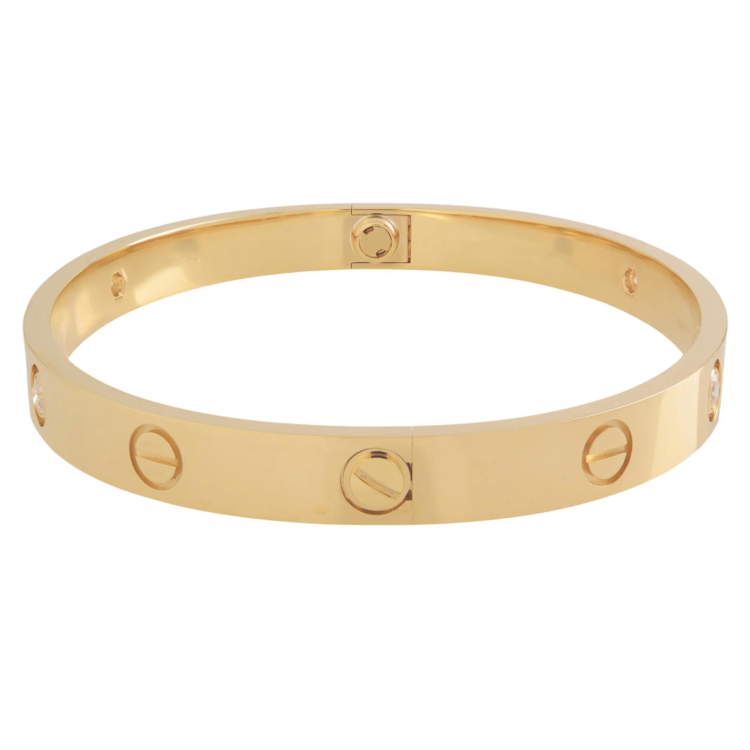An image of a Cartier love unisex adult bracelet with diamonds. The bracelet is shown in a back view, centered and at a medium distance, allowing clear visibility of its design. It features a polished yellow gold bracelet with evenly spaced screw motifs and brilliant-cut diamonds inset at intervals. The angle of the photo provides a clear view of the bangle's outer curve and the reflective quality of both the gold metal and the diamonds. Comes in great preowned condition.