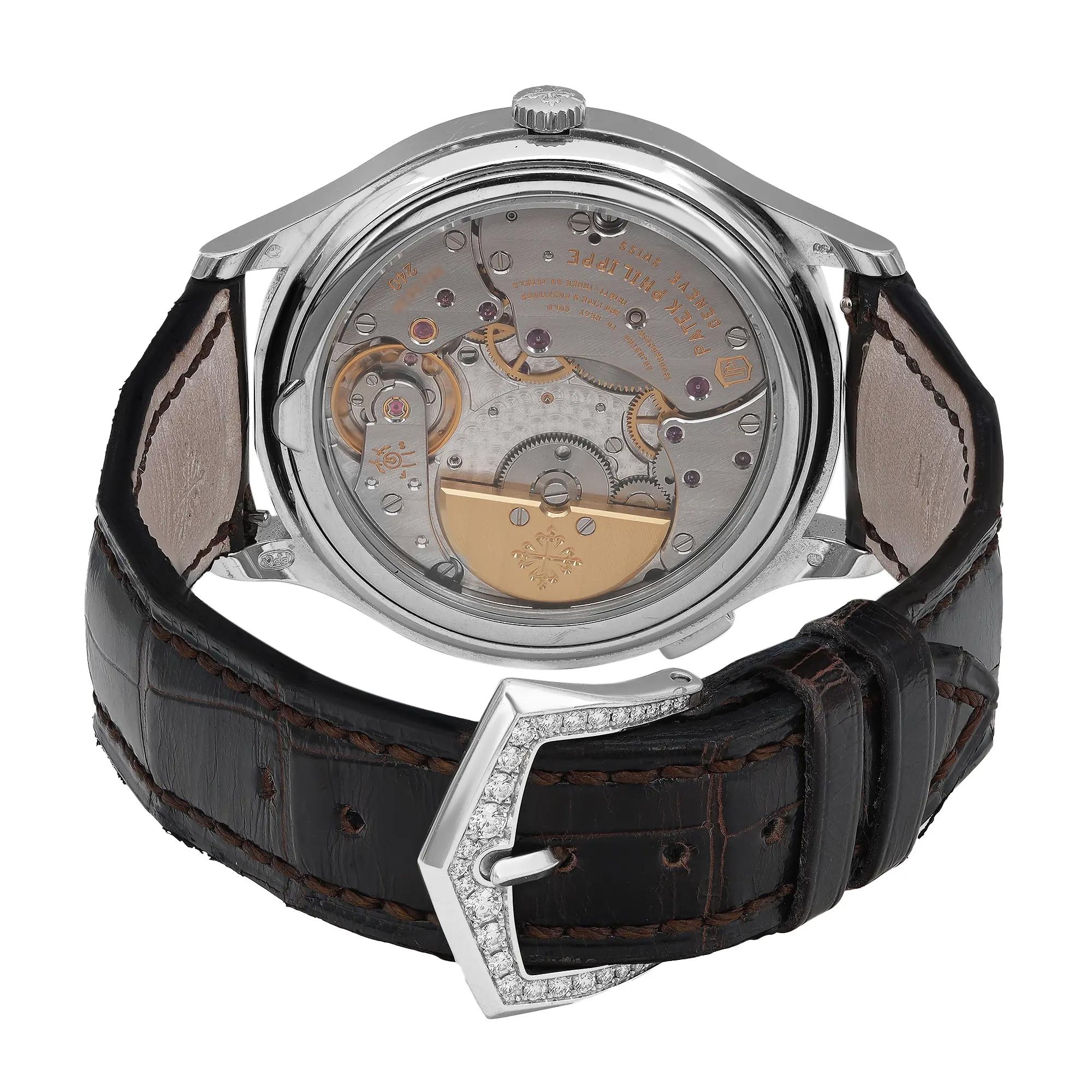 An image of a pre-owned wristwatch showing the back view. The focus is on the intricate mechanical movement inside the watch case, captured from a close distance. The watch is positioned upright with its dark leather strap and closed clasp visible in the foreground.