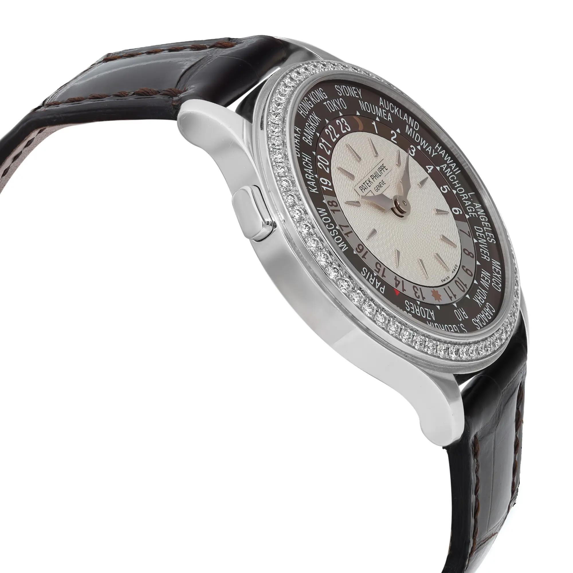 An image of a pre-owned wristwatch captured from a side profile view, opposite the crown. The watch features a detailed face with various city names around the bezel, indicating world time zones. The case is sleek and metallic, with a textured dial. The leather strap is dark and stitched, adding a classic touch. The angle emphasizes the watch's elegant design, highlighting its sophisticated appearance. The photograph is taken at a close distance to showcase intricate details.