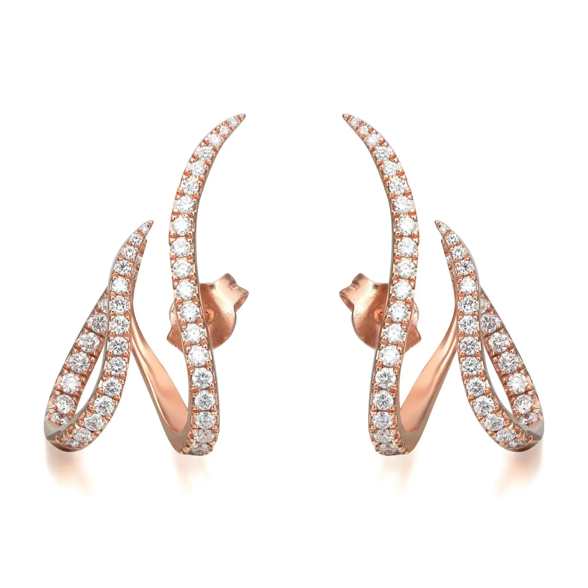 An image of a pair of Messika brand earrings designed for women, featuring a curved design encrusted with multiple small diamonds. The earrings are presented in a symmetrical view, positioned vertically side by side, with the left earring slightly overlapping the right at the bottom. They are set against a white background, and the camera angle is head-on, capturing the earrings in great detail from a close distance, showcasing the sparkle and intricate setting of the diamonds on the rose gold base.