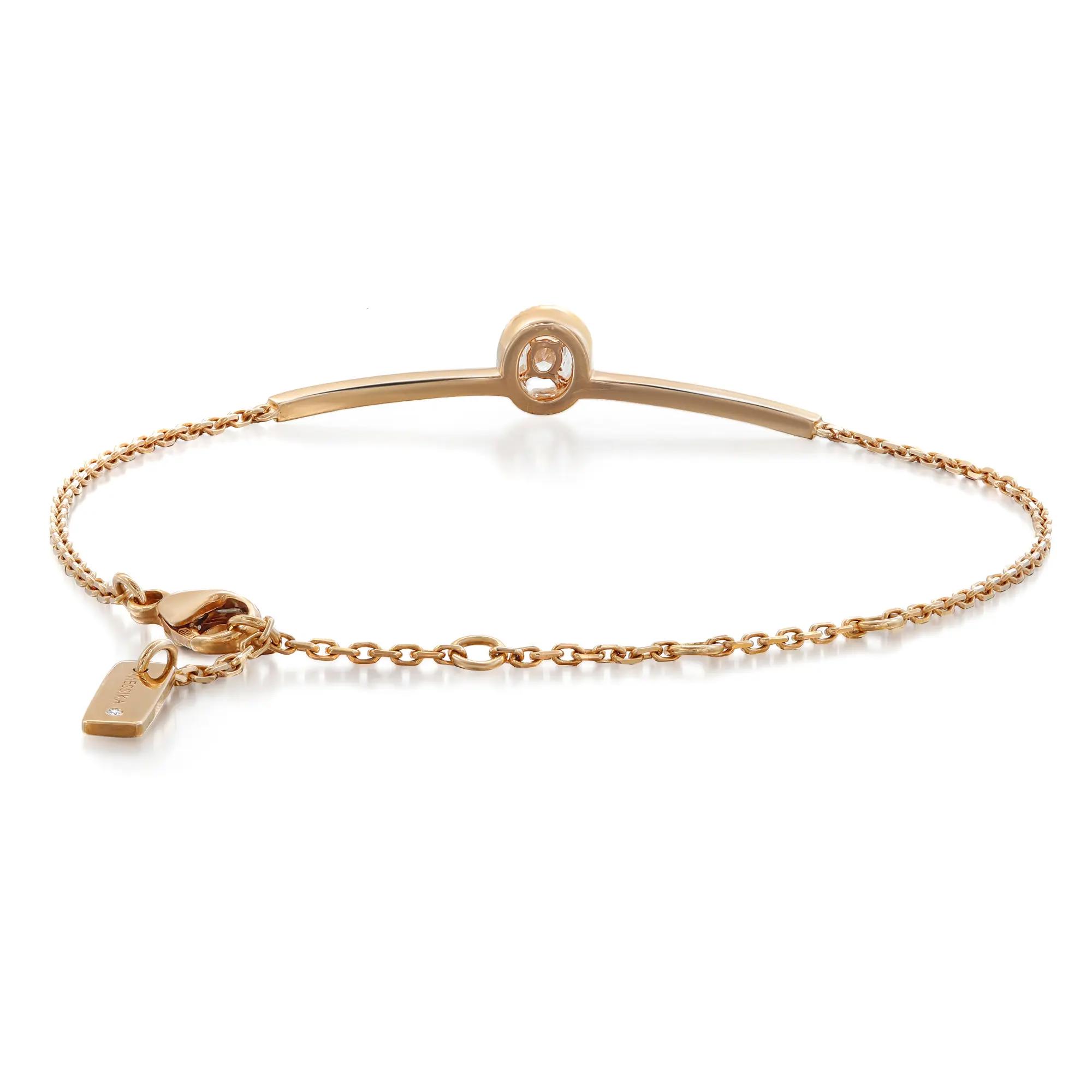 An image of a Messika women's bracelet with diamonds, displayed on a white background. The bracelet features a delicate rose gold bangle at the top with a single diamond set in a circular frame at its center, creating a focal point. The bangle transitions into a fine rose gold chain that loops around to complete the bracelet. The clasp and a small branded tag are visible on the right side. The bracelet is photographed from a top-down angle, with the bangle part facing the viewer straight on, and the chain part extending to the right, slightly receding into the distance for a three-dimensional effect.