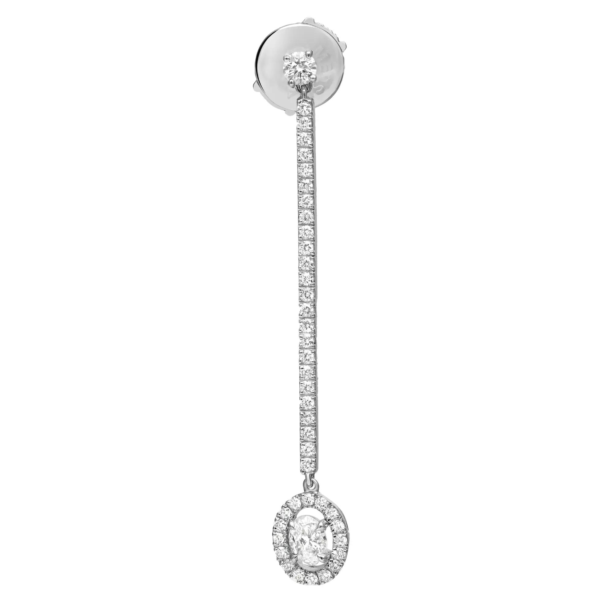 An image of a single Messika Pend Glam'Azone earring designed for women, featuring a linear drop style with diamonds. The earring is displayed in a frontal view against a white background, with the post at the top and a vertical row of small, round-cut diamonds leading down to a larger, round diamond encircled by a halo of smaller diamonds at the bottom. The earring is centered and positioned straight, providing a clear view of its design and the sparkling diamonds from a medium distance.