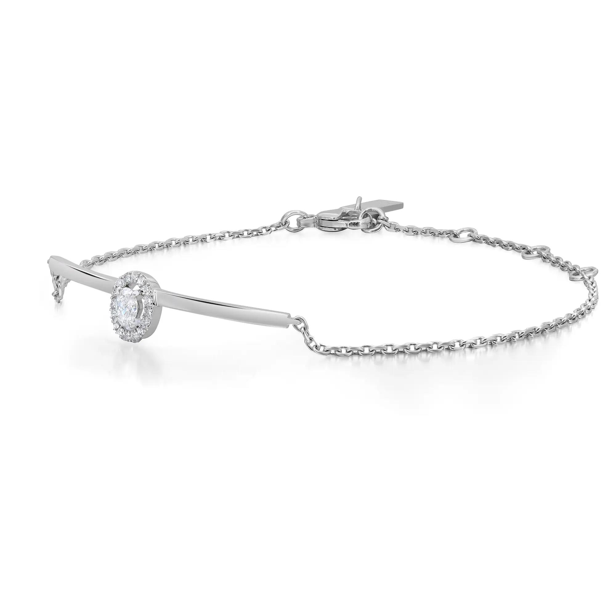 An image of a Messika brand bracelet designed for women, featuring diamonds. The bracelet is displayed against a white background with a close-up view, showing fine detail. It has a slender chain with a delicate clasp and a central diamond-encrusted feature that appears to be in a bezel setting. The image is taken from a slightly elevated angle, emphasizing the sparkle of the diamonds and the polished finish of the metal. The bracelet is positioned horizontally across the frame, with the diamond feature slightly off-center to the right, providing a clear view of its design and craftsmanship.