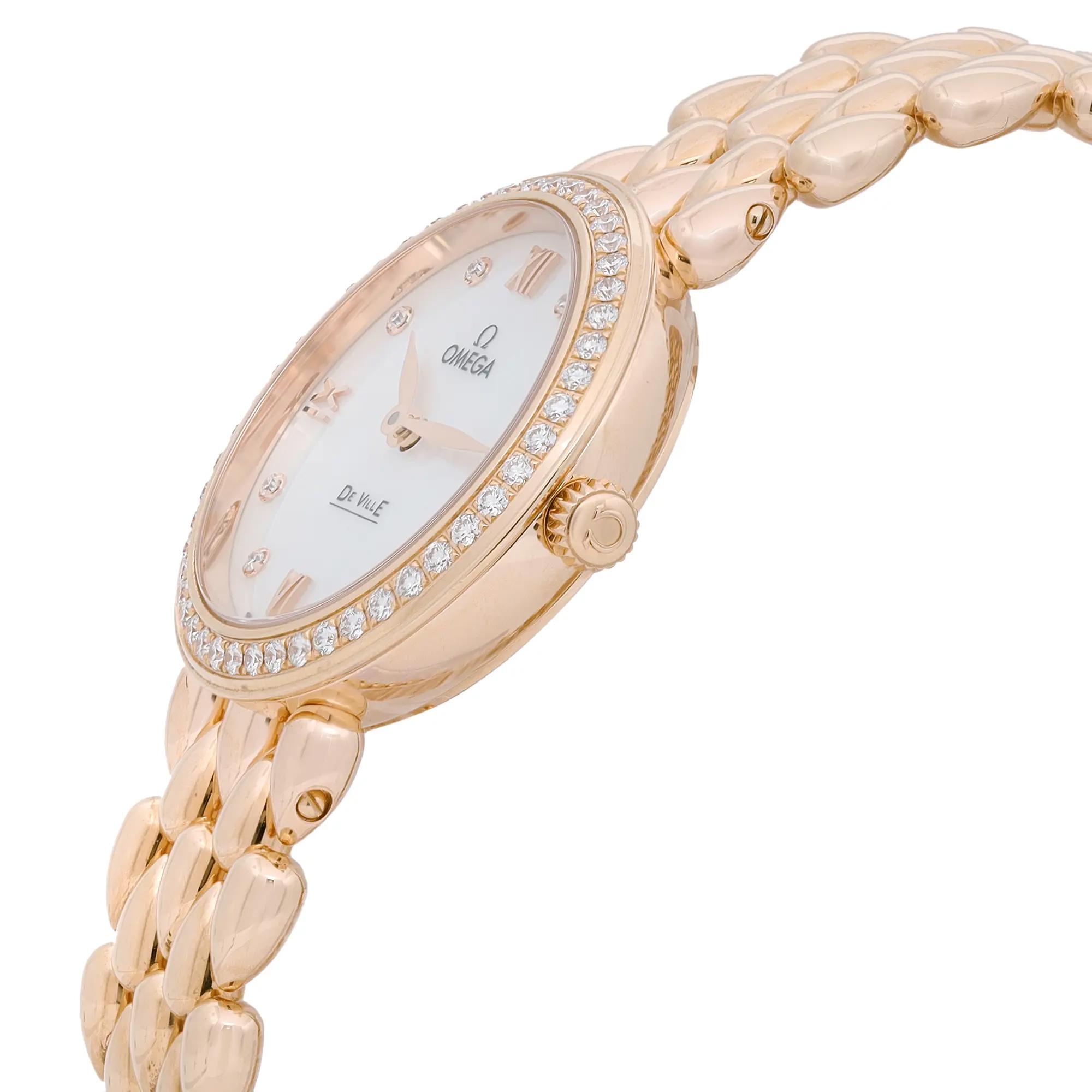 An image of a wristwatch taken from a side profile view, showcasing the crown prominently. The watch features a gold-toned band with a textured, linked design. The bezel is encrusted with small diamonds, and the face has Roman numeral indices. The distance is close-up, highlighting the intricate details and luxurious finish of the display model.