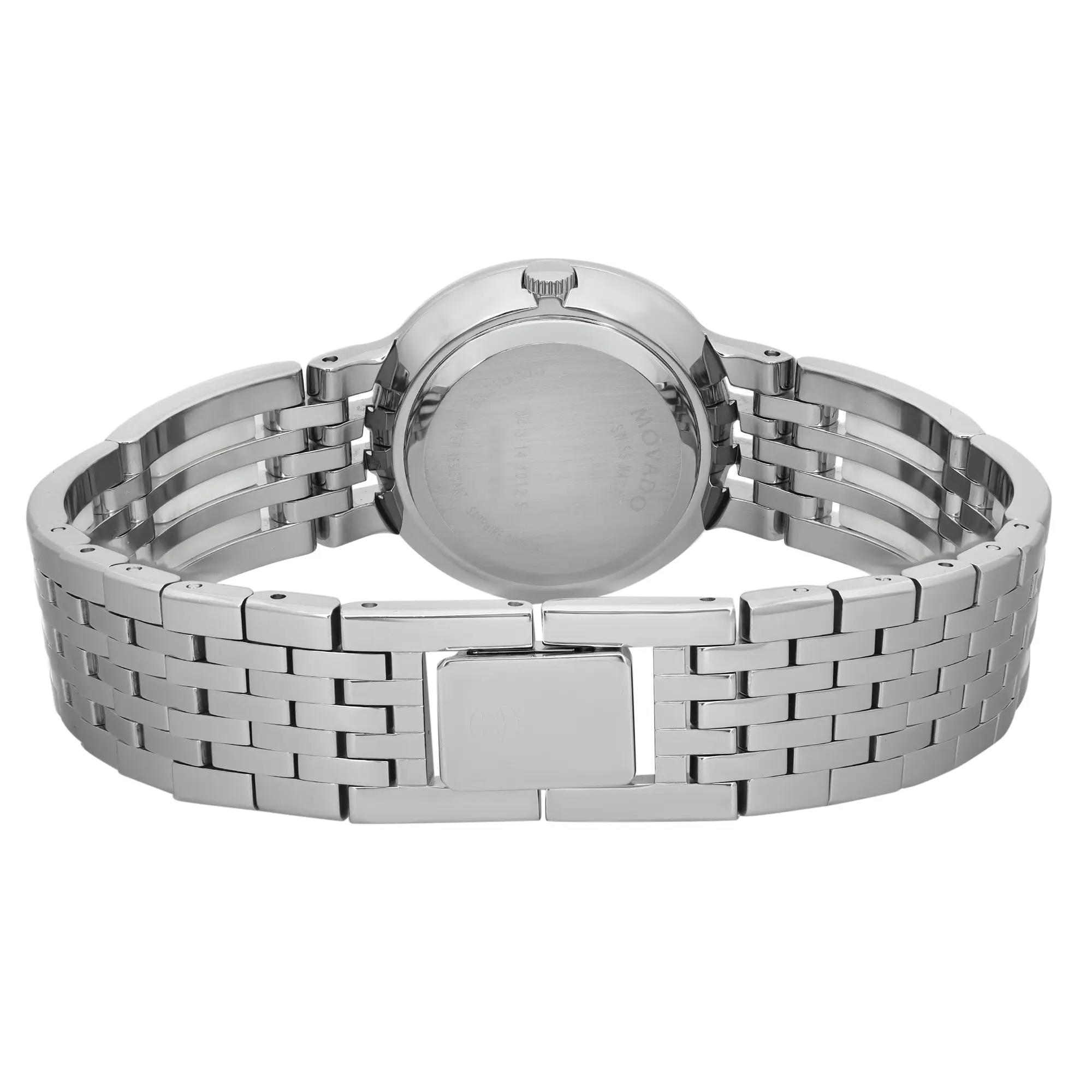 An image of a pre-owned Movado women's wristwatch, viewed from the back. The focus is on the closed jewelry clasp, highlighting the stainless steel and ceramic band. The round stainless steel case features a snap caseback. The angle is direct and close, emphasizing the sleek design and materials.