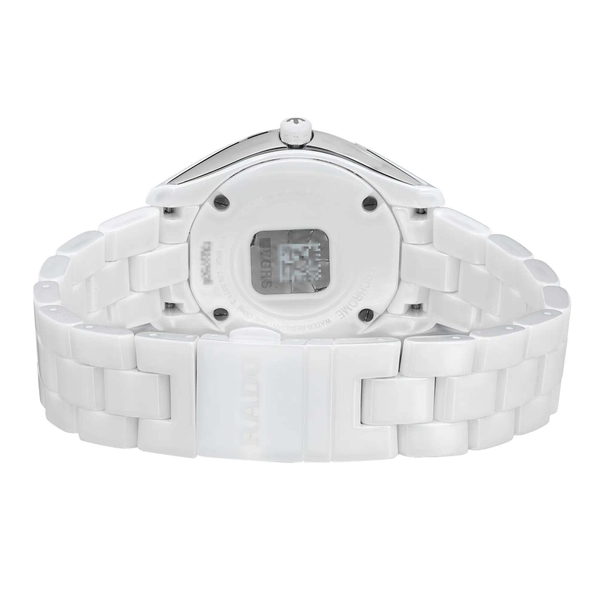 An image of an unworn Rado women's wristwatch showcasing the back view with a closed clasp. The watch features a round shape, a screwback case made of ceramic and stainless steel, and a ceramic band. It is designed with a fold-over clasp with double push-button closure. The angle of the photo is a close-up, centered on the watch's caseback, with the band extending to the sides of the frame, The watch is depicted against a white background.