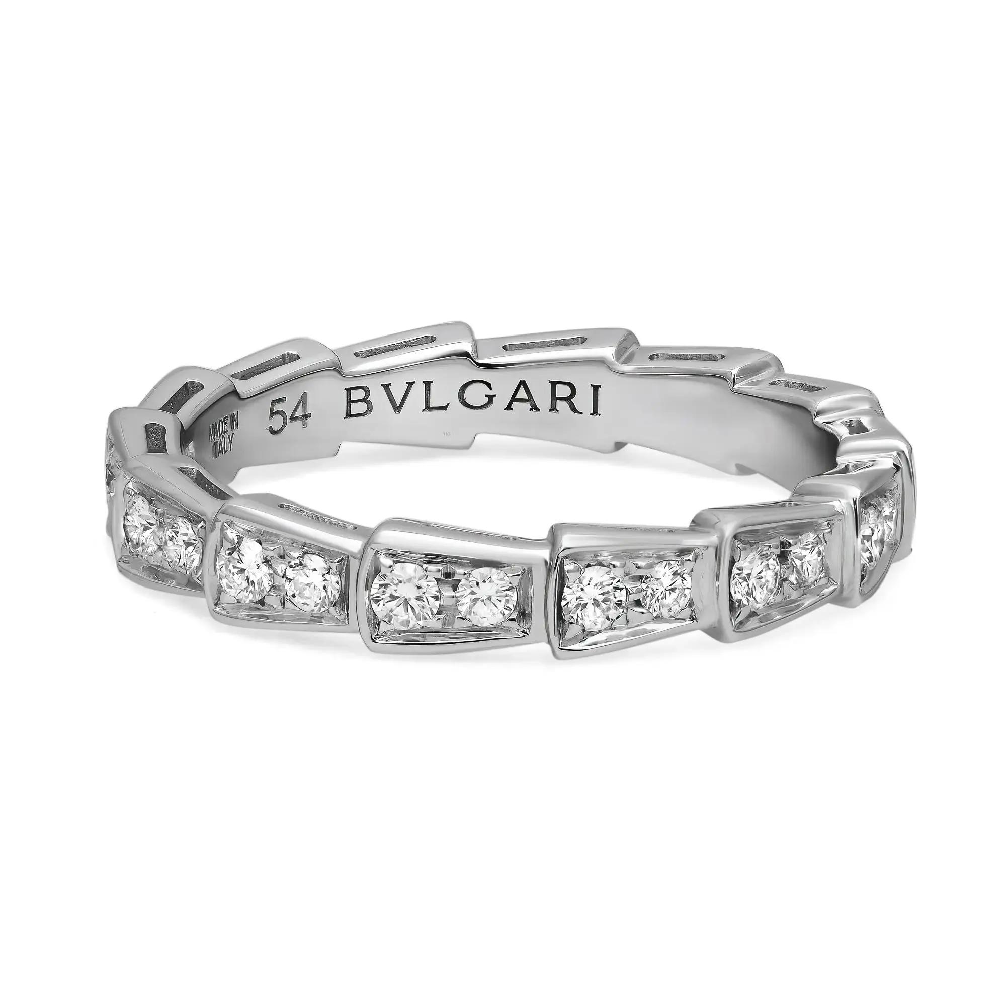 An image of a Bvlgari Serpenti Viper women's 18k white gold ring with diamonds, captured in high resolution at a close distance. The ring is displayed at a slight angle showcasing the brand's name engraved on the band. The diamonds are set in a geometric pattern around the entirety of the band, reflecting light and emphasizing their cut and clarity. The photo is taken against a white background to highlight the ring's design and features.